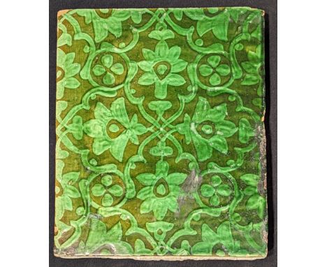 A 19th century Indian green glazed pottery tile, 26.5cm x 21.5cm