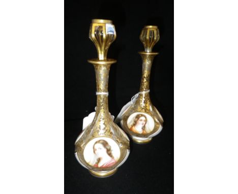A PAIR OF VICTORIAN WHITE OVERLAID AND GILT DECORATED PERFUME BOTTLES, each decorated with floral panels and a portrait of a 