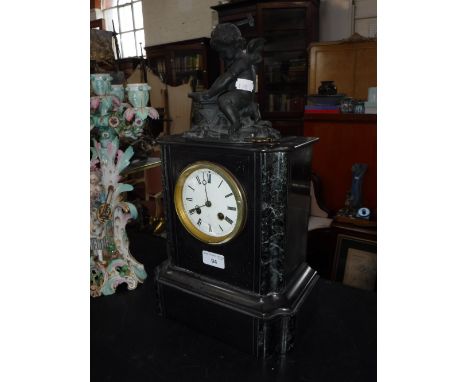 A 19TH CENTURY SLATE-CASED MANTEL CLOCK, decorated with a cherub on top heating an arrow on an anvil (key in office)
