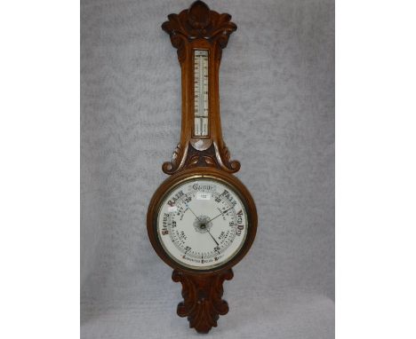 A VICTORIAN OAK-CASED ANEROID BAROMETER
