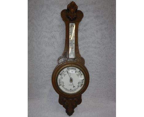A VICTORIAN OAK ANEROID BAROMETER, inscribed 'Tilley & Son, Dorchester'