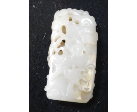 A SMALL CARVED JADE ORNAMENT  with floral decoration