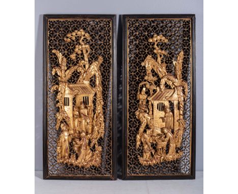 Each pierced and carved with figures before an architectural setting beneath a large pine tree, all reserved on a pierced geo