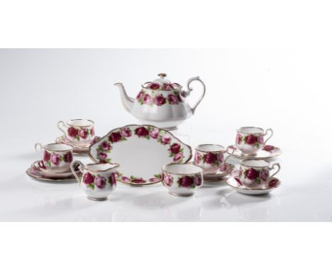 Comprising: 12 tea cups &amp; saucers, 12 cake plates, a tea pot, a creamer, 2 milk jugs, 2 sugar bowls and a cake platter   