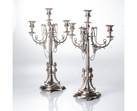 Circa 1900, each tapering fluted column terminating in domed bases with three bracket feet, the central column and three bran