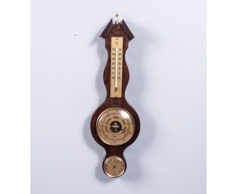 The circular white dial, with brass bezel below the central thermometer, with second subsidiary dial, 43cm in length   