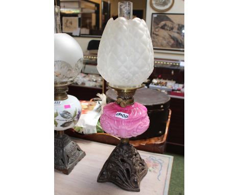 Victorian Opaque pink glass reservoir Oil lamp with cast metal base 