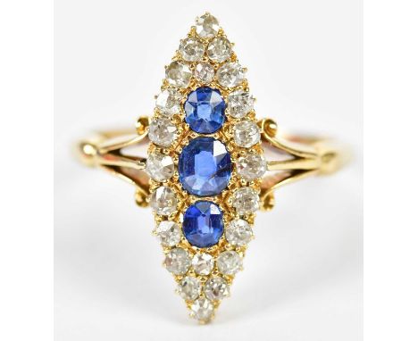 An 18ct yellow gold sapphire and diamond boat shaped ring centred with three sapphires within a framework of twenty-two diamo