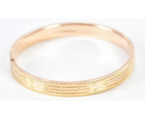 A 9ct rose gold bangle with engraved detail, approx. 10.7g, external diameter 75mm, internal diameter 70mm, width 10mm.Condit