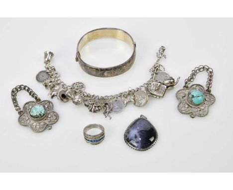 A silver hinged bangle, a silver charm bracelet, a dress ring, a pendant and a pair of rough turquoise set white metal plaque