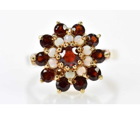 A 9ct rose gold garnet and opal cluster ring (one opal missing), size L 1/2, approx. 3.8g.
