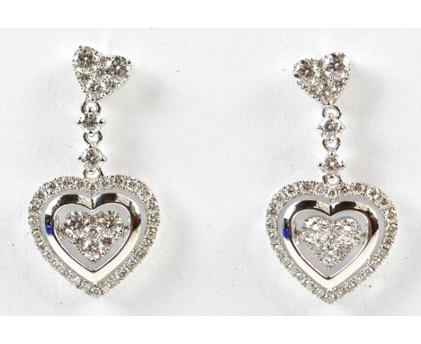A pair of 18ct white gold diamond set heart shaped drop earrings in the manner of Chopard, length 25mm, combined approx. 5.1g