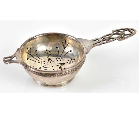 LEE SILVER &amp; CO; a George VI hallmarked silver tea strainer and bowl with cast open floral decoration, Sheffield 1947, ap