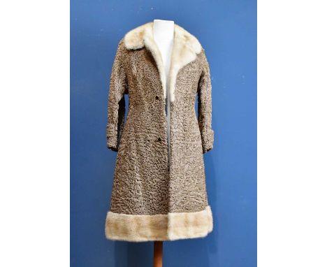 A light brown vintage Persian lamb full length coat trimmed with cream fur to base and collar, with cabochon black and gold t