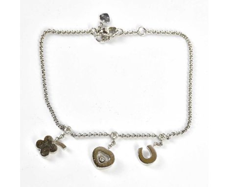 CHOPARD; an 18ct white gold 'Happy Diamonds' bracelet/anklet set with three charms and four diamonds, length approx. 24cm, ap