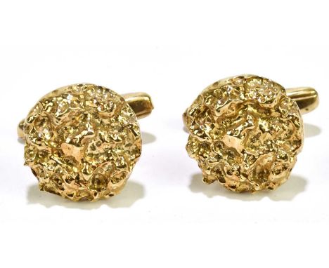 A pair of yellow metal cufflinks with textured circular platforms and torpedo backs, approx 12.1g.Condition Report: Marks hea