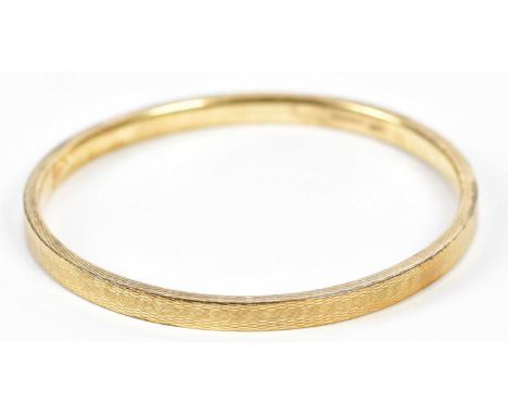 A 9ct yellow gold bangle, approx. 10.3g, external diameter 85mm, internal diameter 77mm, width 6mm.Condition Report: A couple