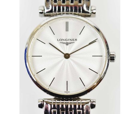 LONGINES; a lady's stainless steel wristwatch, the engine turned dial set with batons, diameter excluding winding crown 24mm,