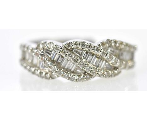 An 18ct white gold diamond ring set with both baguette and brilliant cut diamonds in a swept design, size R, approx 6g.