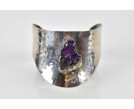 J HULL; a Danish brushed pewter and raw amethyst bangle.