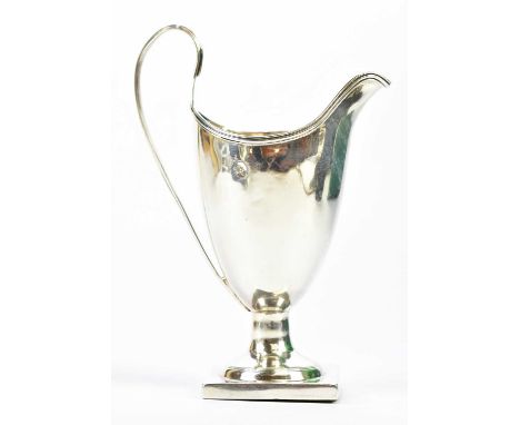 SAMUEL ADAMS II; a George III hallmarked silver helmet shaped jug on square plinth, London 1793 (weighted), height 14cm.