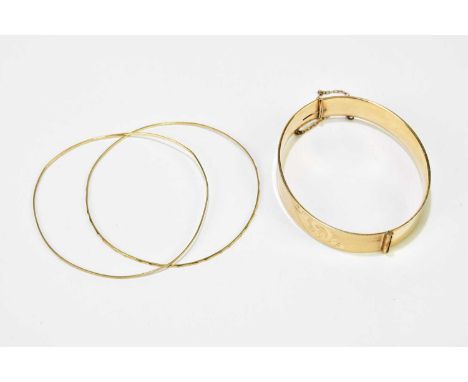 Two 15ct yellow gold very thin fine bangles, combined 4g, and a gold plated bangle (3)