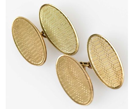 A pair of 9ct yellow gold cufflinks with engraved oval platforms, combined approx 12.8g.