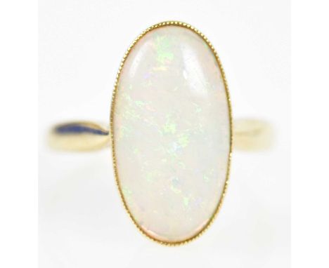A 14ct yellow gold and oval opal cabochon ring, size L, approx. 3.1g.Provenance: Length of ring head 17.95mm.