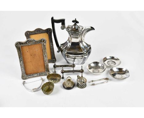 A pair of hallmarked silver mounted easel back photograph frames, Chester 1909, three white metal pin dishes set with coins, 