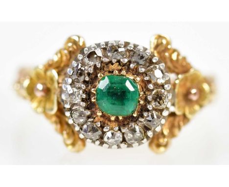 An antique yellow metal emerald and diamond ring with flower head detail to the shoulders, size Q1/2, approx 5.1g.