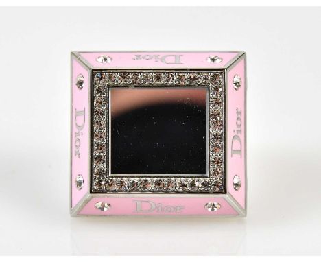 CHRISTIAN DIOR; a pink stainless steel Dior pink Princess ring, set with Swarovski crystals, mirror with lip make-up inside, 