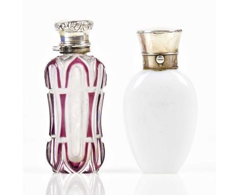 A Victorian opaque glass with hallmarked silver perfume bottle of oval form, London 1864, height 9cm, and a Victorian cut gla