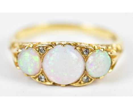A yellow metal opal and diamond ring set with three cabochon opals and four diamond chips, size P, approx 3.8g.Condition Repo