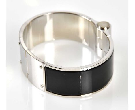 HERMÈS; a black enamel and silver Charniere bracelet with Hermès embossed to side, 7cm across, in original box with pouch.Con