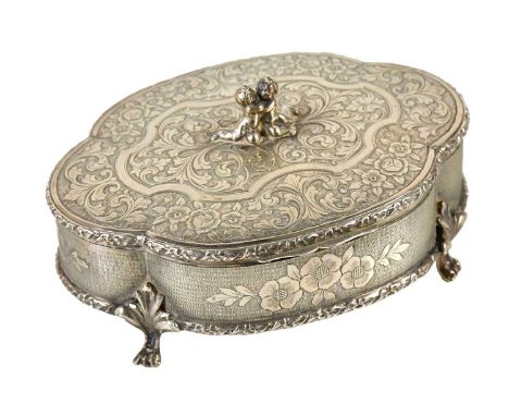A Continental 800 grade silver trinket box and cover of quatroform shape, the cover with applied seated cherubs and scrolling