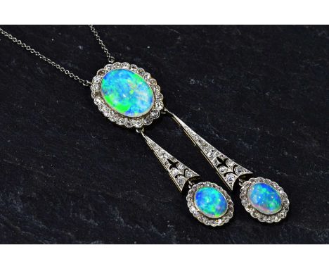 An Edwardian 15ct yellow gold diamond and opal necklace, the fine link chain supporting an upper oval platform with central o