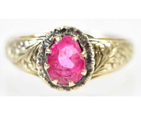 A yellow metal pink sapphire ring with engraved detail to the shoulders, size P, approx 4.3g.Condition Report: The stone has 