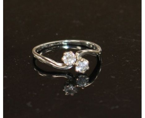 An 18ct and Plat, two stone diamond crossover ring, size P/Q, gross weight 2.5 grams. Condition: Stones approx. 0.13ct &amp; 