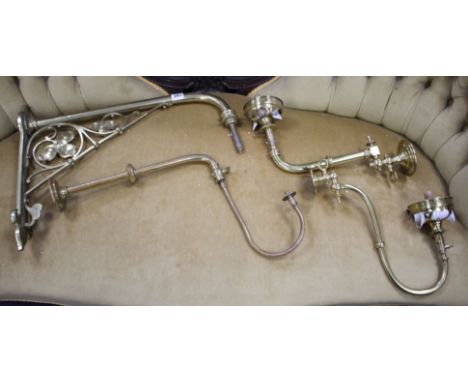 Three assorted brass gas wall light fittings and a larger drop wall light bracket Condition:- one gas light with original cer