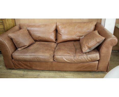 A Heals brown leather sofa, W.220cm D.94cm H.72cm Condition: The leather has marks and scratches due to use