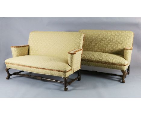 A Queen Anne upholstered scroll arm sofa and a matching reproduction sofa, with cabriole legs, turned stretchers and pad feet