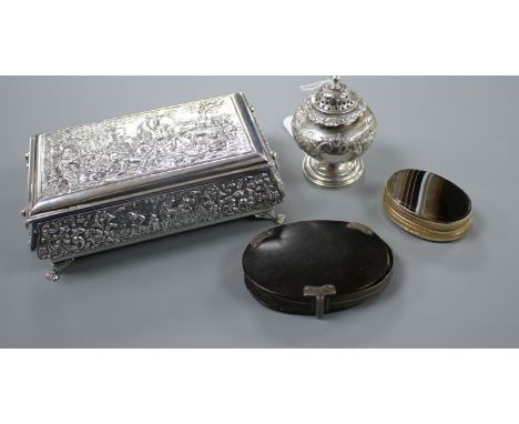 A George IV silver pepperette, a continental repousse white metal trinket box, a tortoiseshell mounted magnifying glass and a