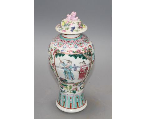 A 19th century Chinese famille rose baluster vase and cover, height 24cm Condition: Top finial figure with chips to one ear, 