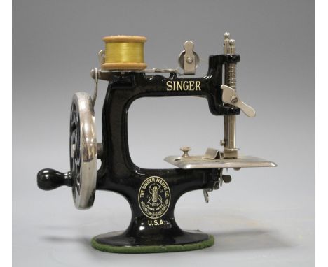 A miniature Singer sewing machine, height 16cm Condition: Looks to be in good working condition, one small rusted patch at th