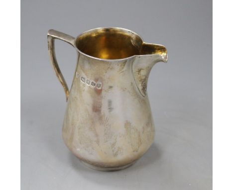 A 1970's silver cream jug by Brian Leslie Fuller, London, 1977, height 92mm, 5.5 oz. Condition: Some tarnishing, otherwise in