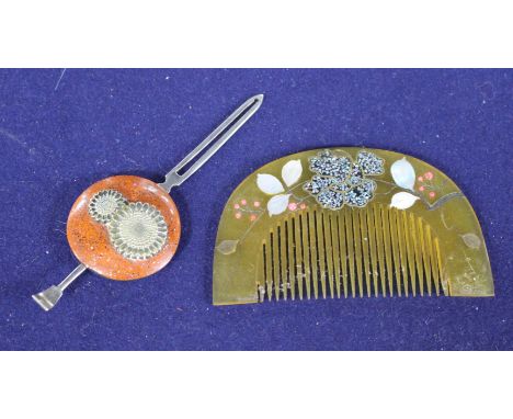 An early 20th century Japanese lacquered metal hair clip decorated with flowers, 11.5cm and a mother of pearl inset horn comb