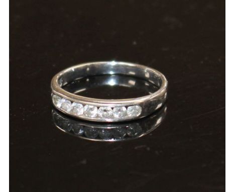 A modern 18ct white gold and seven stone diamond set half eternity ring, size L, gross weight 2.2 grams. Condition: Total dia