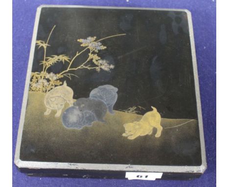 A Japanese Meiji lacquer writing box, the lid decorated with five puppies playing in a garden, underside of the lid with bird