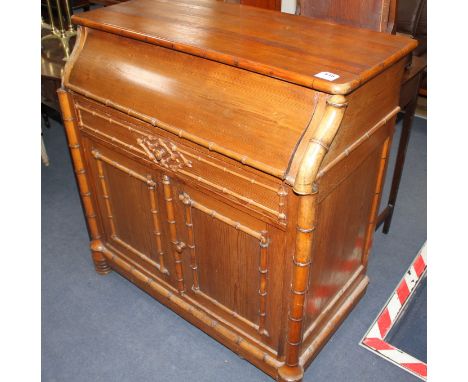 An Edwardian pine washstand, the rising top opening to reveal marble lined interior and mirror, over a drawer and bamboo moul