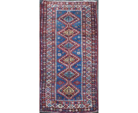 A Kazak Caucasian runner, woven with a central row of six large lozenges, within a multiple geometric border, c.1890, 244 x 1